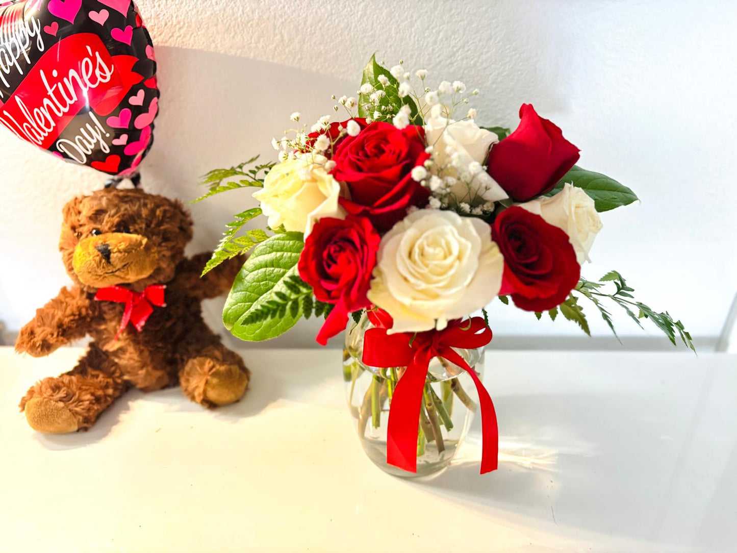 A Dozen White and Red Roses in Vase